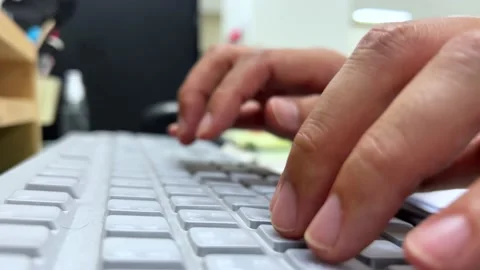 A hand tapping on a computer keyboard Stock Footage 195489291