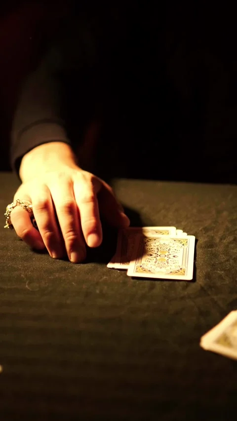 Hand tapping fingers on dark table near playing cards, gambling and betting Vidéo 335828542