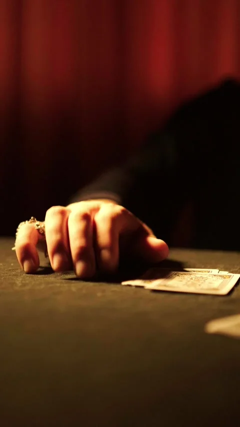 Hand tapping fingers on dark table near playing cards, gambling and betting Vidéo 335828562