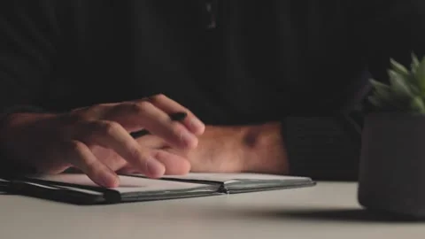 Hand Tapping Pen on Notebook at Desk Close Video stock 346809825