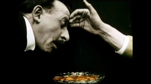 Hand Taps The Forehead Of A Man That Produces Coins From His Mouth Stock Footage 97476721