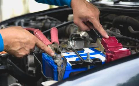Hand of technician checking engine of car. Auto mechanic checking car engine. Stock Photos