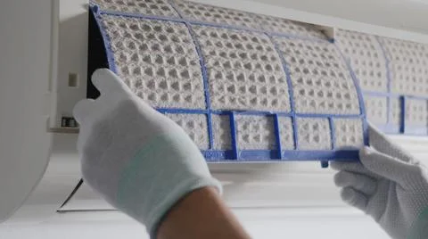 Hand of technician man working pulling dusty filter from air conditioner Stock Photos