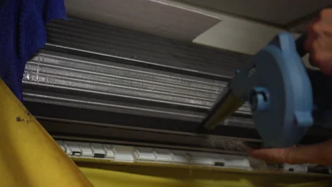 Hand of technician service cleaning air conditioner by water spray and blow d Stock Footage 162802129