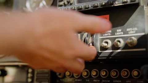 Hand testing and flipping switches on light plane cockpit Stock Footage 310986469