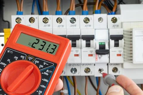 Hand Testing Electrical Circuit with Multimeter Stock Photos