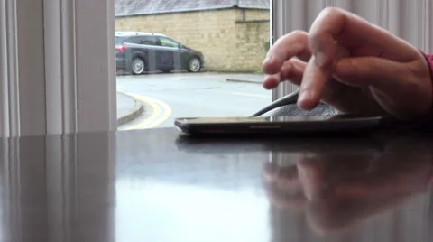 Hand texting a message using mobile phone on the table of a cafe Stock-Footage 58144732