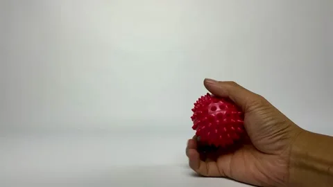Hand Therapy with Red Spiky Massage Ball Stock Footage 329610620