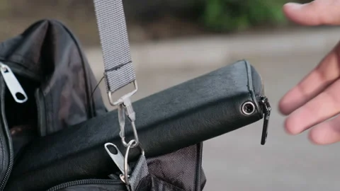 Hand of a thief stealing a sloppy lying purse in a bag Stock Footage 130133911