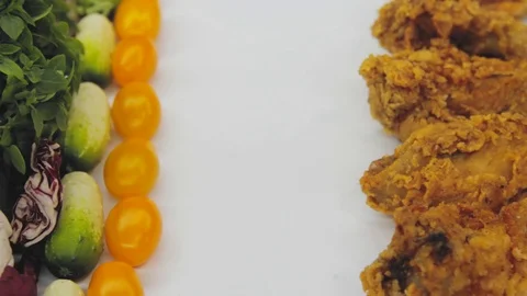 Hand in thought chooses between junk food and healthy food decides to take both Stock Footage 125653681