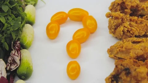 Hand in thought chooses between junk food and healthy food decides to take both Stock Footage 125653732