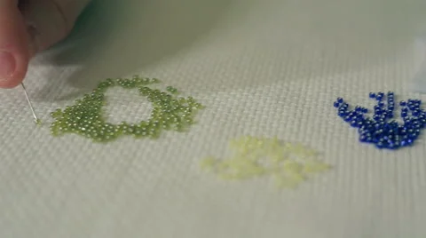 Hand is threading glass beads Stock Footage 67986560