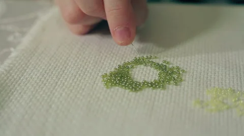 Hand is threading glass beads Stock Footage 67986813