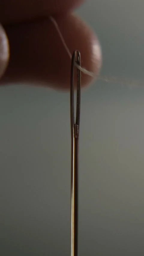 Hand threading needle with white thread Stock Footage 322218987