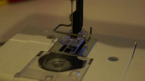 Hand threads the needle of a sewing machine, above the foot and bobbin Stock Footage 52181265