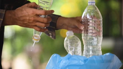 Hand throw away plastic bottles into the trash. Stock Footage 130164746