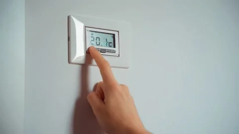 Hand throw down cold home heating trouble. Thermostat showing cold temperature. Stock Footage 220524825