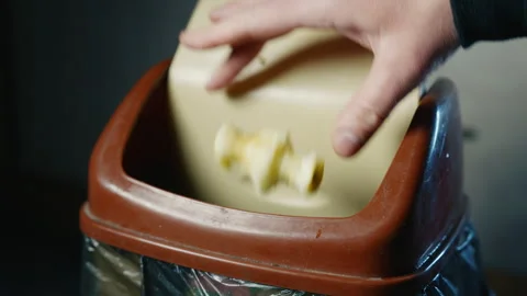 Hand Throwing Apple Core Missing Trash Bin in Slow Motion | Food Waste Disposal Stock Footage 326843059