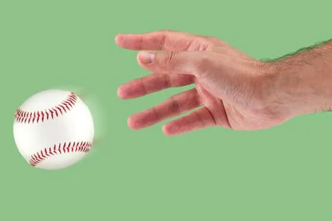 A hand throwing a baseball Stock Photos