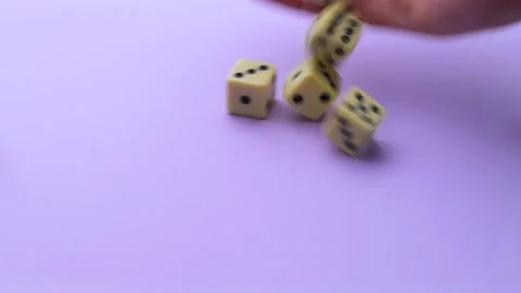 Hand throwing dice on purple table Stock Footage 273247666