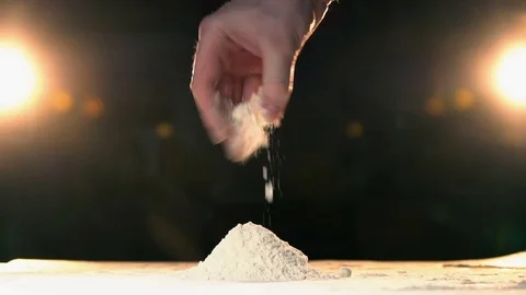 Hand throwing flour in a heap rapid. Hand throws white powder mountain slow mo. Video stock 72920052