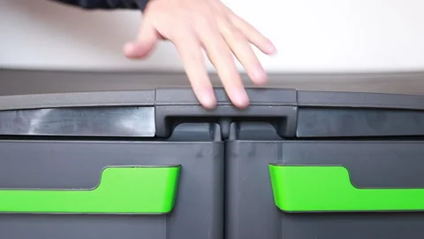 Hand throwing garbage bag into undifferentiated bucket Stock Footage 147494957