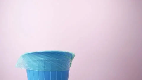 Hand throwing old CD disk away, trash bin electronic gadget inside, phone in  Stock Footage 172005440