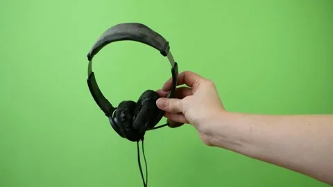 Hand throwing old shabby decrepit headphones away, electronic waste, goodbye  Video stock 168489424