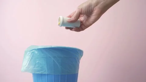 Hand throwing pills away, trash bin with pills and blisters inside, medecine  Stock Footage 163544825