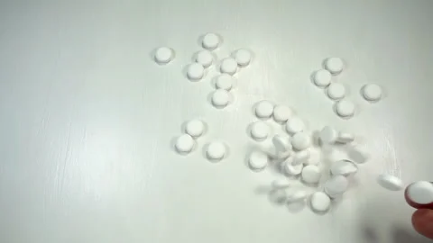 Hand throwing of pills in slow motion Stock Footage 140775137