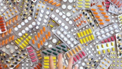 Hand throwing pills table. Arm Grabs tablet good white background. Stock Footage 72914744