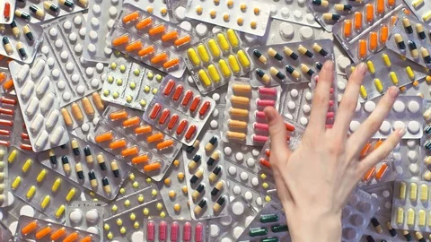 Hand throwing pills table. Arm Grabs tablet good white background. Stock Footage 72928012