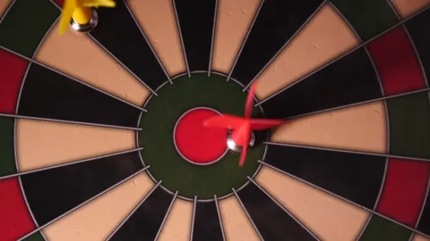 Hand throwing red dart at board in slow motion close up game being played Stock Footage 205430566