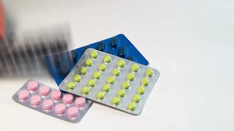 A hand throws a blister with black pills on several blisters lying Video stock 196267985