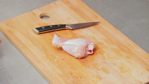 Hand throws a chicken leg on the board Stock-Footage 232810256