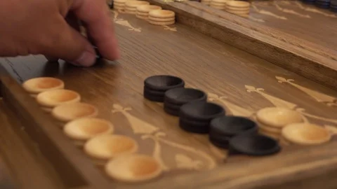 Hand throws dice on a backgammon board Stock Footage 91385896