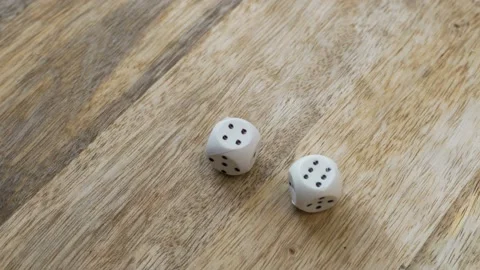 The Hand Throws the Dice on the Wooden Surface. The Numbers 4 and 6 Appear on th Video stock 141666733