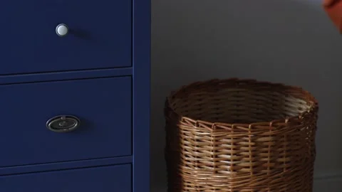 Hand throws dirty towel into laundry basket Stock Footage 167783640