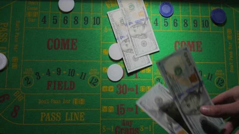 Hand throws down five hundred dollars on craps table slow motion Stock Footage 153952166