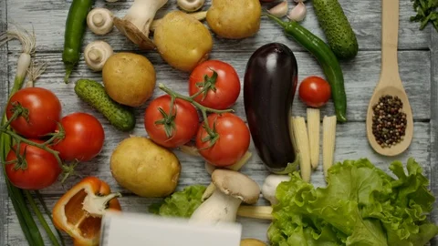 Hand throws a notepad for recipes on the table with vegetables Stock Footage 121484036