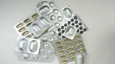 Hand throws pills in blisters in 4K Stock Footage 142959851