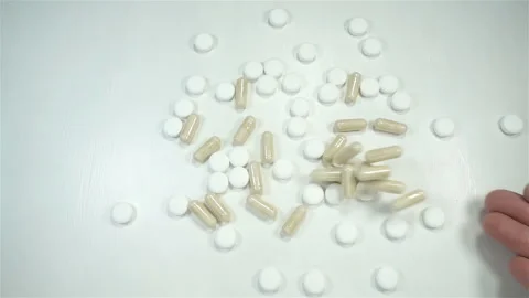 Hand throws pills in slow motion Video stock 146680826