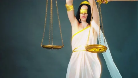 Hand throws puts money coins on scales. Woman Greek goddess of justice Themis Stock Footage 234618284