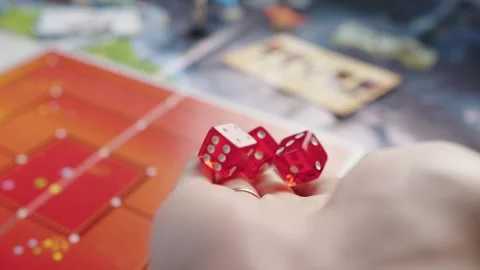 The hand throws red dices on the playing field. Gaming moments in dynamics. Stock Footage 282154556