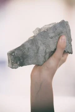 Hand throws a stone Stock Photos
