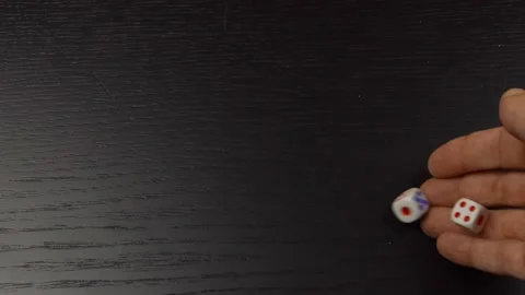 The hand throws two dice on the wooden table. Close-up Stock Footage 145638694