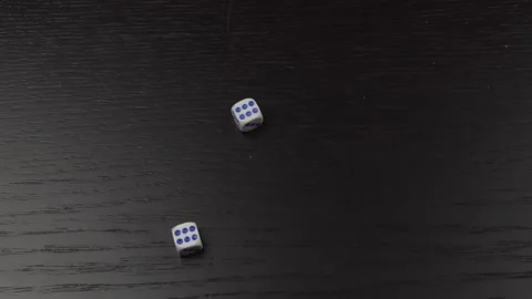 The hand throws two dice on the wooden table. Close-up Stock Footage 145638833
