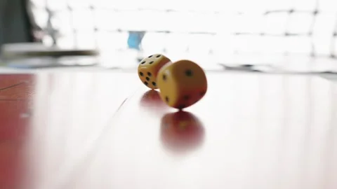 The hand throws yellow dices on the playing field. Gaming moments in dynamics Stock Footage 282153803