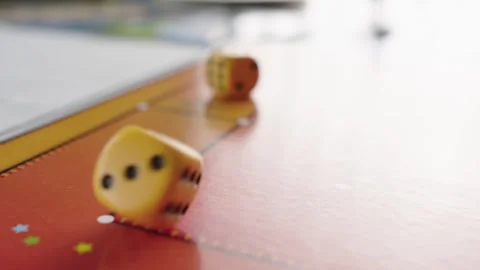 The hand throws yellow dices on the playing field. Gaming moments in dynamics Stock Footage 282153904