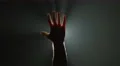 The hand thumb up on the background of bright light. Real time capture 4k or 4k+ Resolution